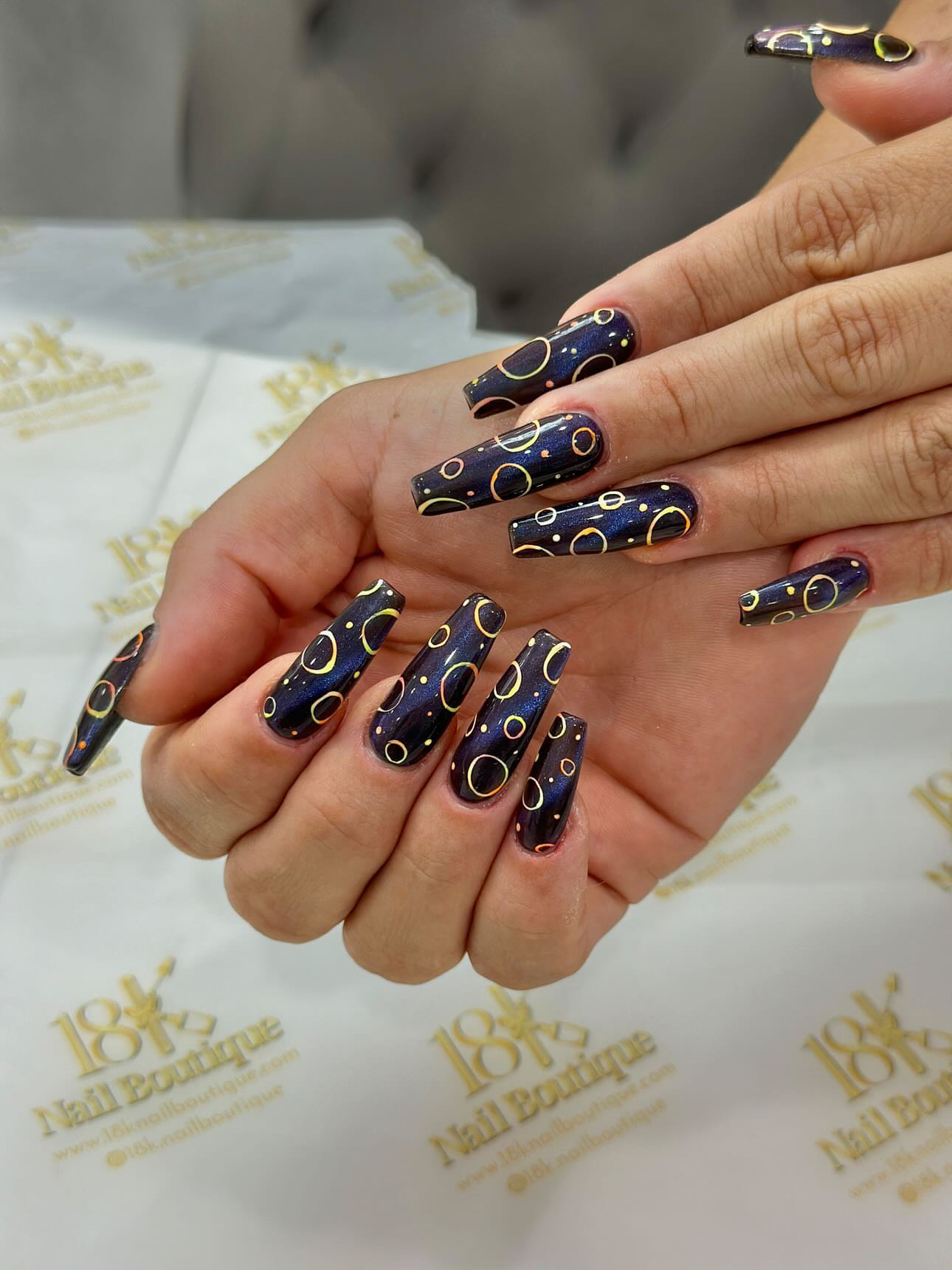 Galaxy dark nail art with gold circles